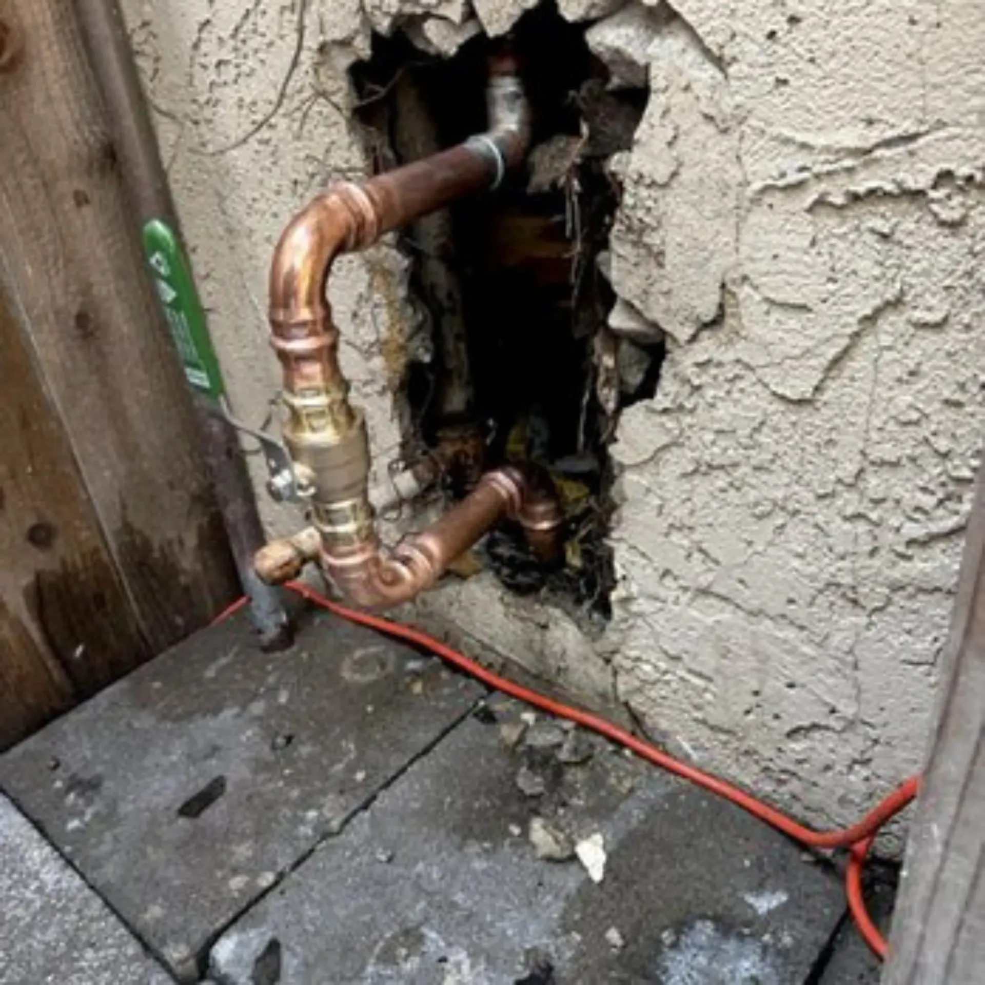 GTZ Plumbing Service LLC - Copper pipes coming out of a hole in a wall