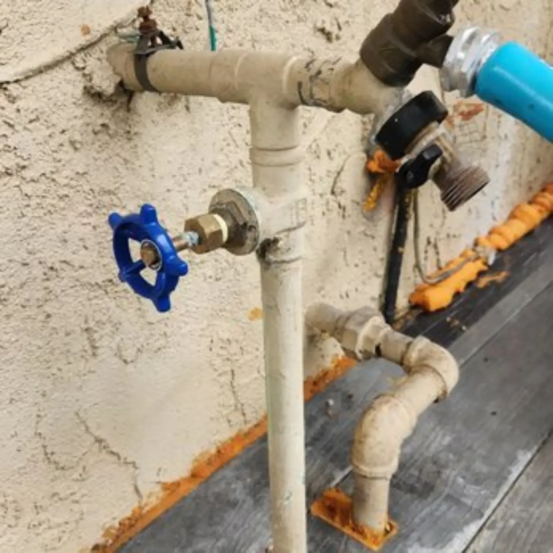 GTZ Plumbing Service LLC - A pipe with a blue valve attached to it