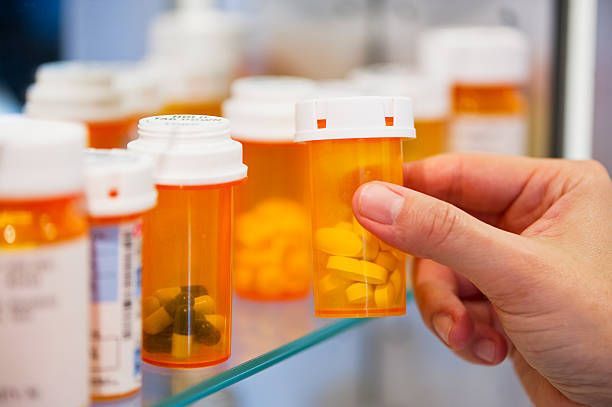 A woman is holding a baby while sitting on a couch with two other women.