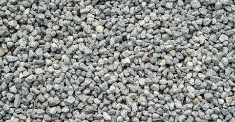 A pile of gravel is sitting on the ground.