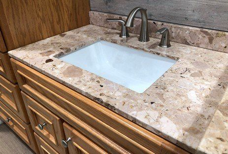 Bathroom Remodel Materials — Granite Counter with White Under Mount Rectangular Sink in Hillburn, NY