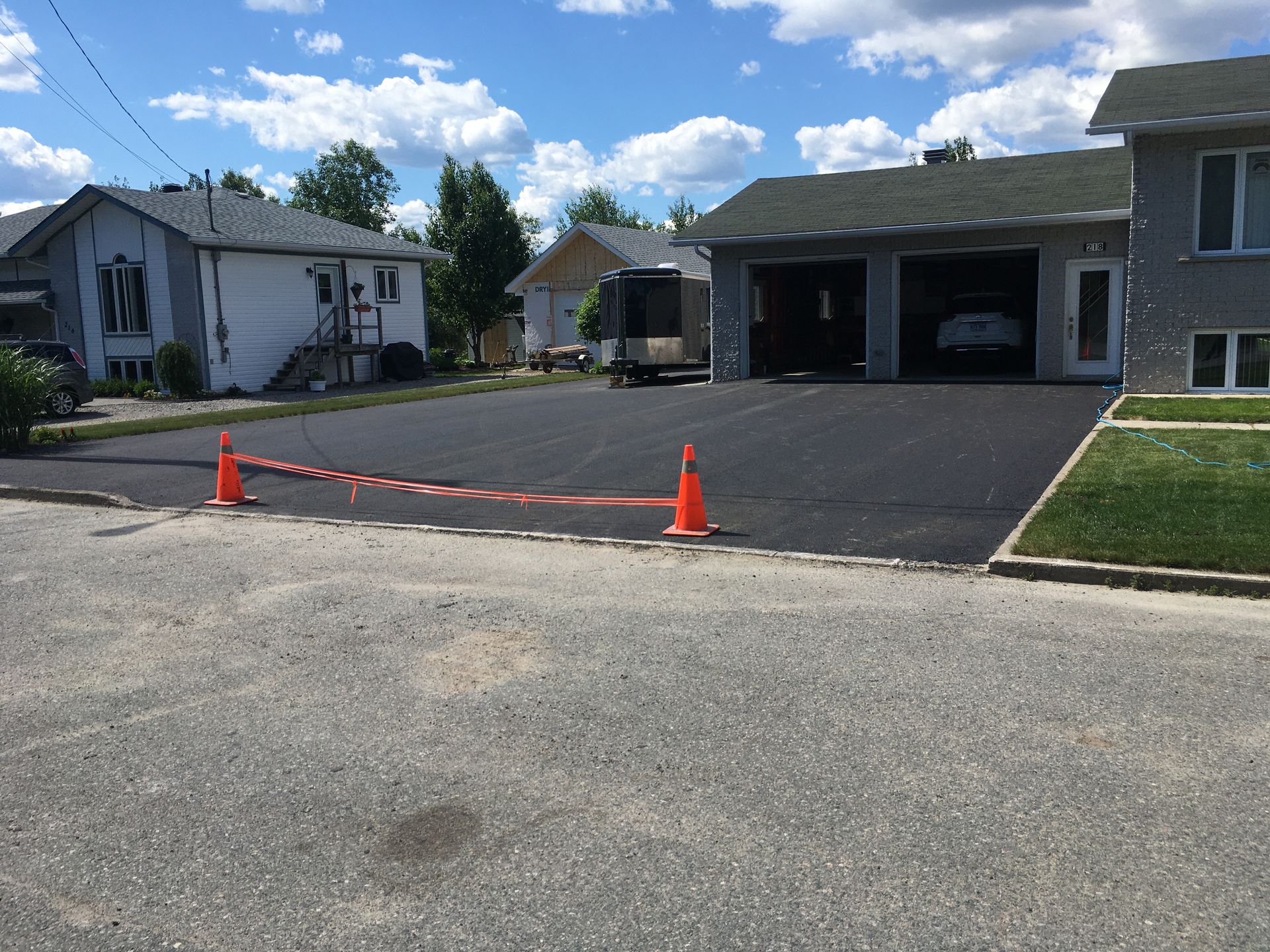 Une voiture est garée dans un garage devant une maison.