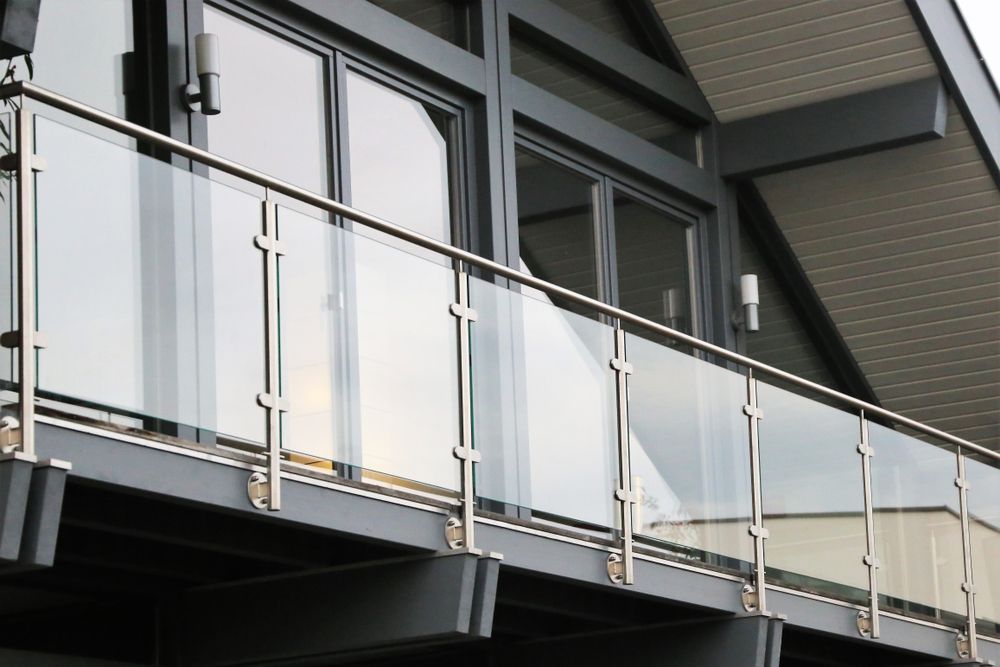 A Modern Balcony with Glass Panels and Metal Railings — Downs Window Renewals in Harristown, QLD