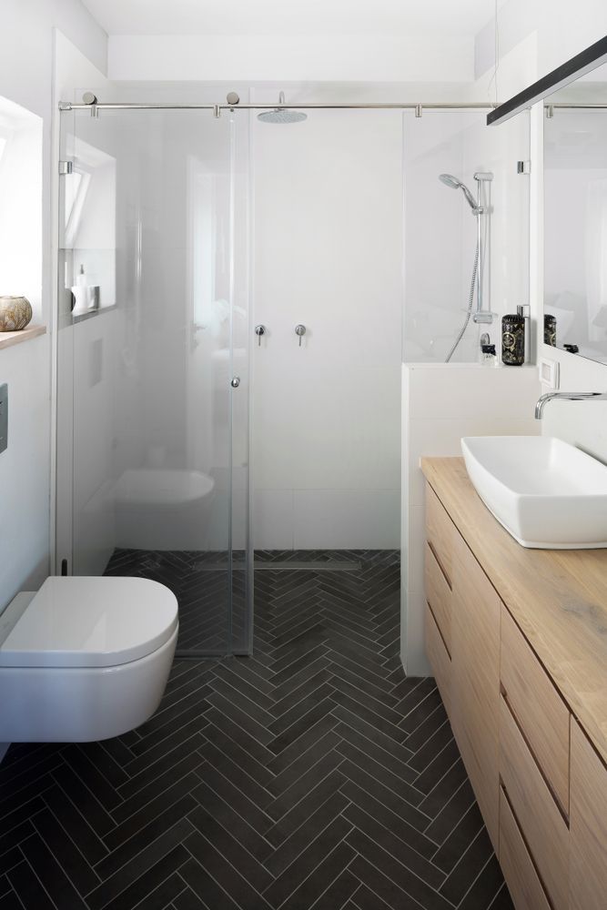 A Modern Bathroom with Black Herringbone Floor — Downs Window Renewals in Harristown, QLD
