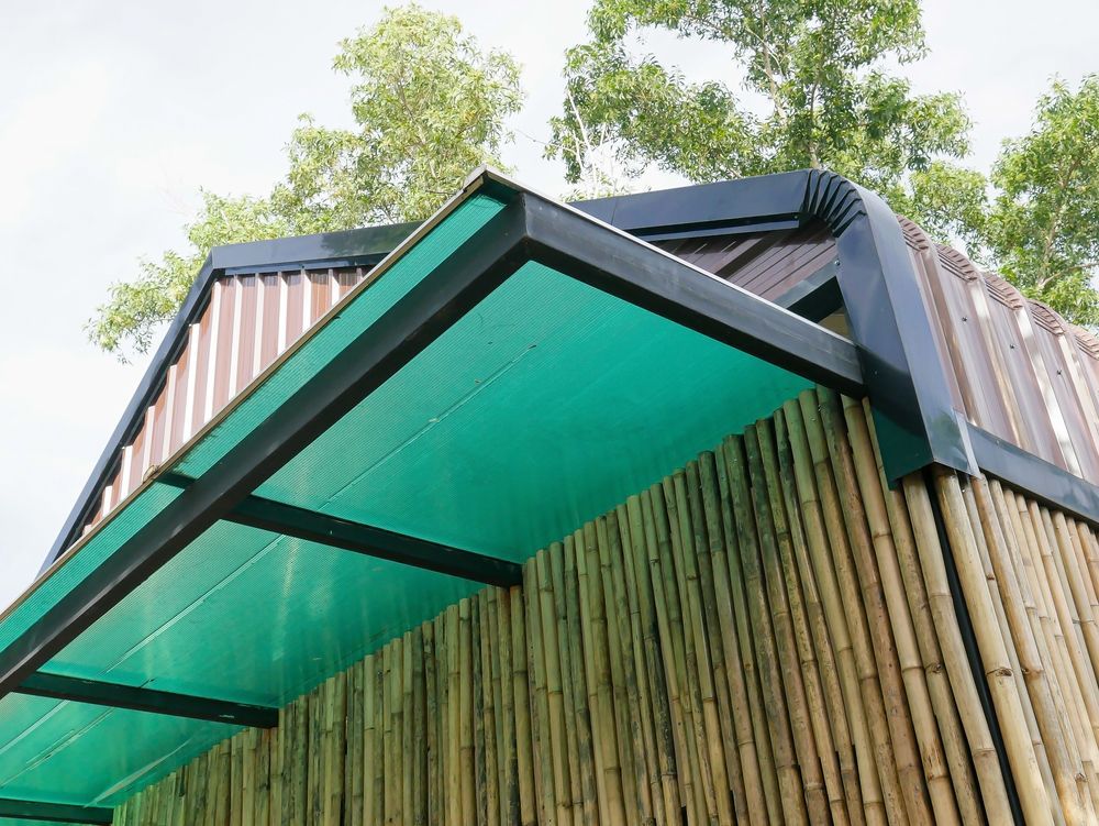 A Green Awning Over Bamboo-Walled Structure — Downs Window Renewals in Harristown, QLD