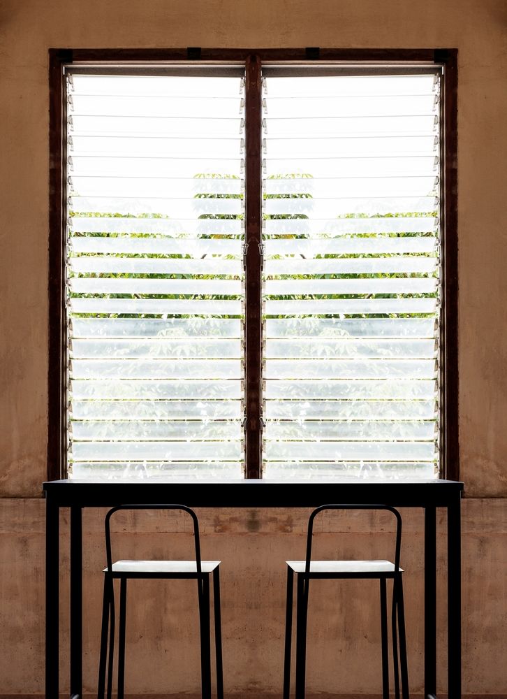 Two Chairs Face a Window with Blinds — Downs Window Renewals in Harristown, QLD