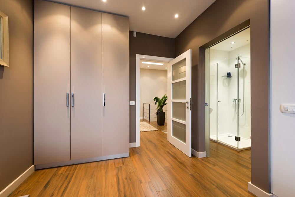 A Hallway with Wood Floors, Gray Wardrobe — Downs Window Renewals in Harristown, QLD