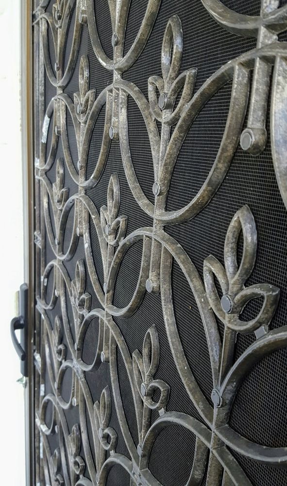 Ornate Metal Security Door with Intricate Scrollwork — Downs Window Renewals in Harristown, QLD