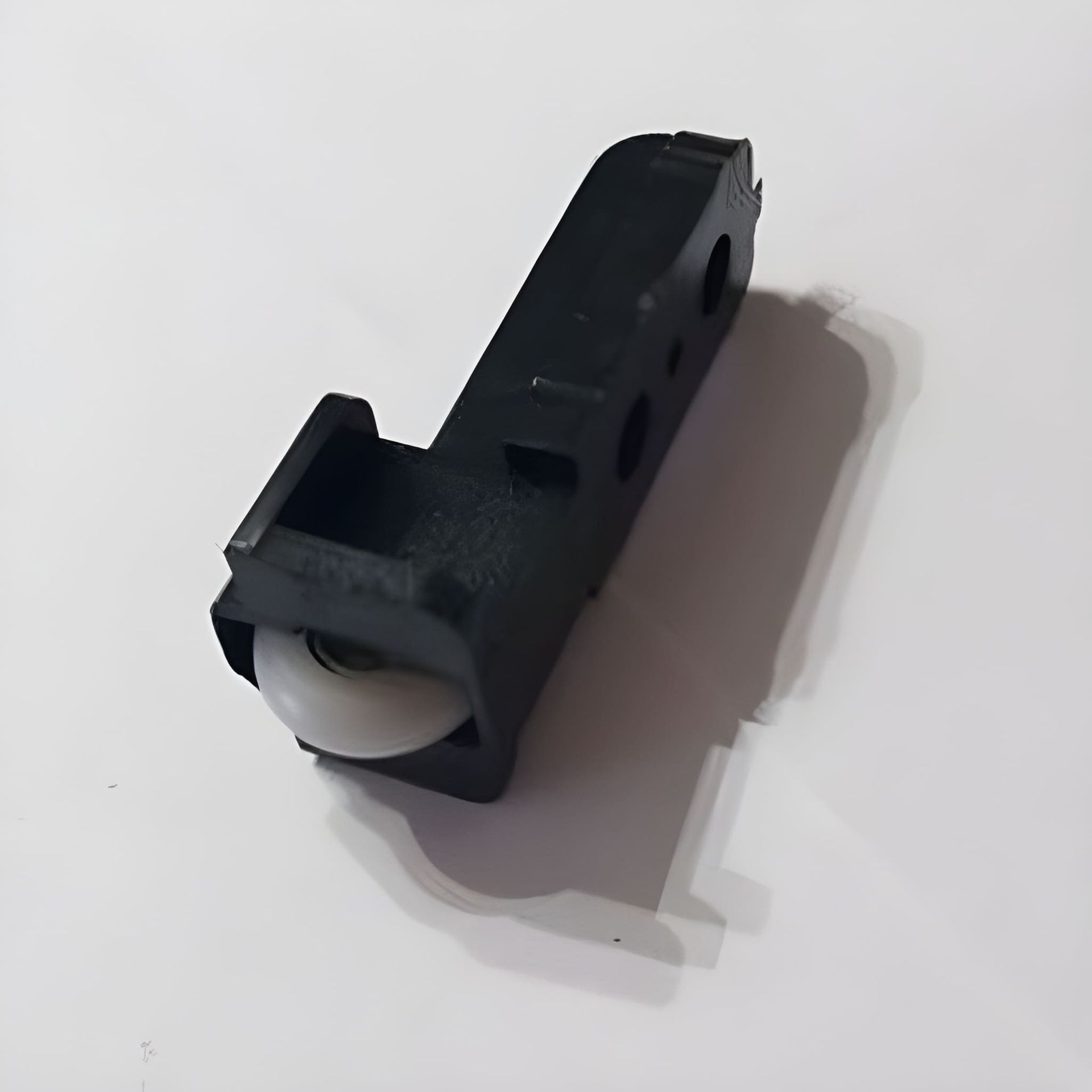 A Black Window Roller with A White Wheel — Downs Window Renewals in Harristown, QLD