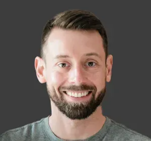 A man with a beard is smiling for the camera.