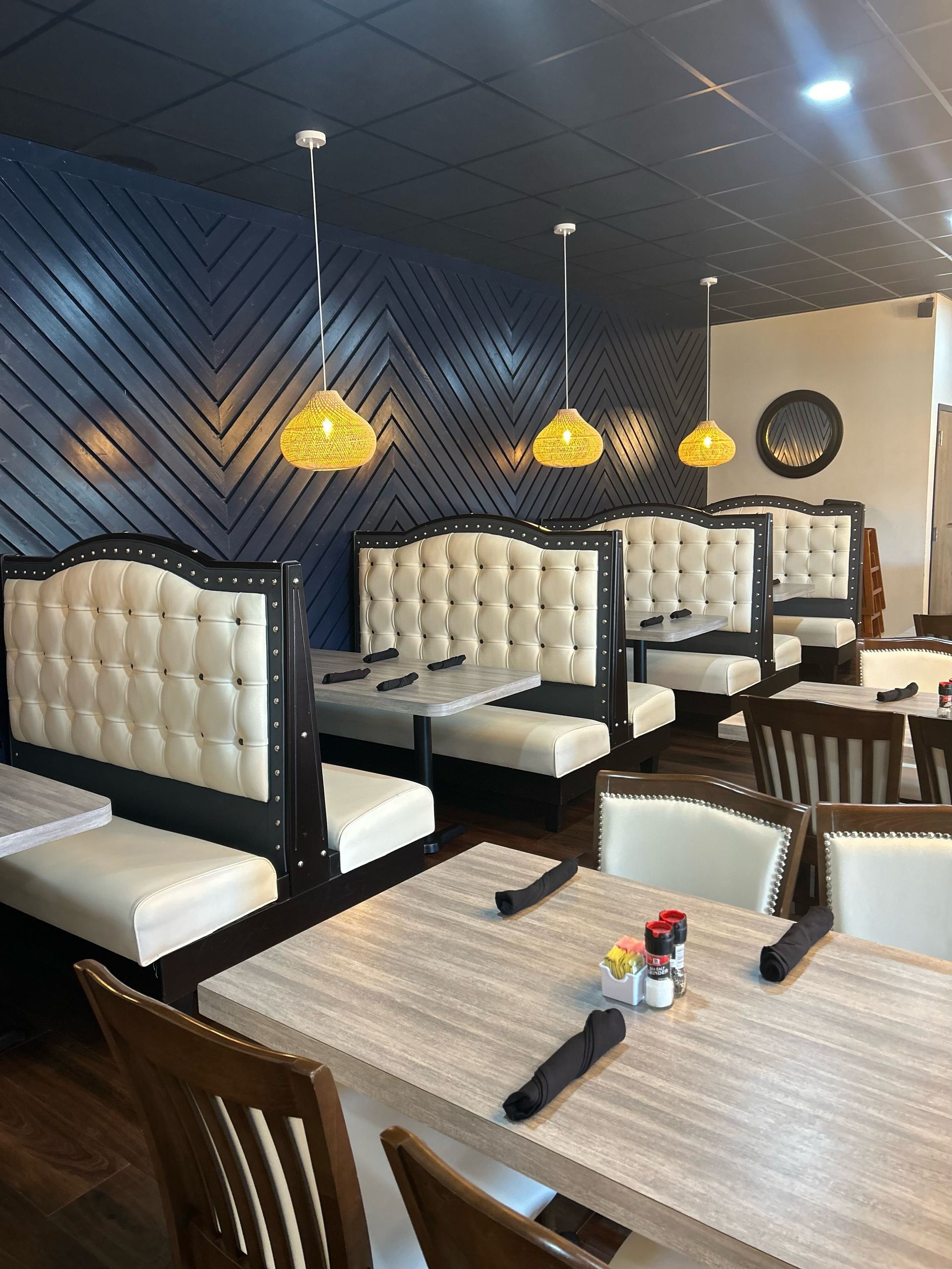 A restaurant with tables and chairs and a blue wall