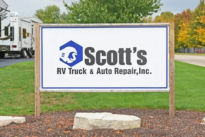 Sign for Scott's RV Truck & Auto Repair, Inc. with logo of a ram in a hexagon.