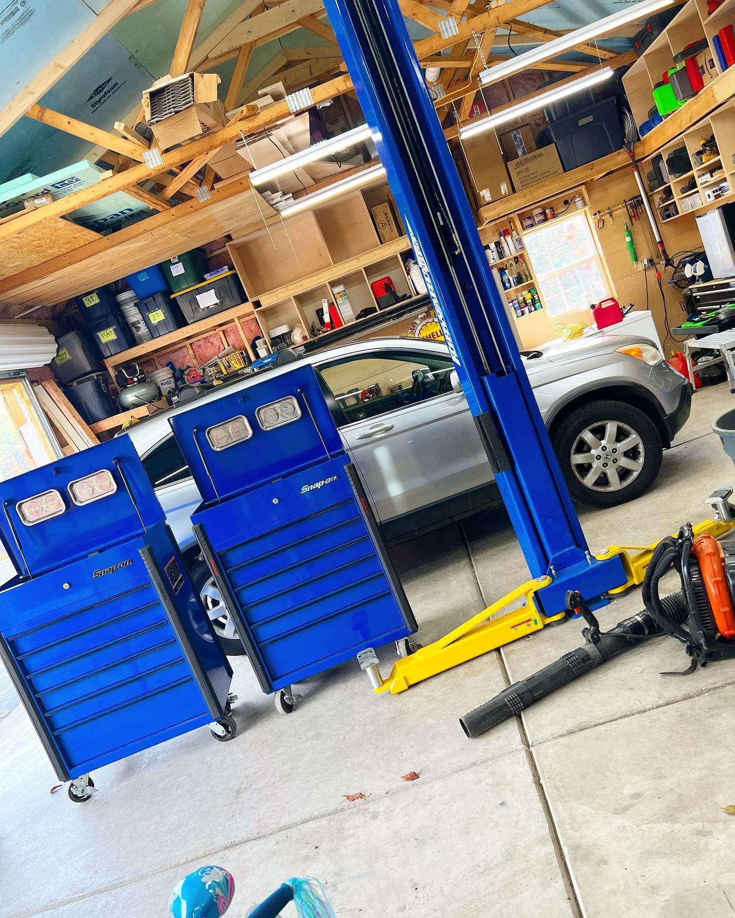 Garage With Toolboxes And Vehicle On Lift | PDub’s Garage LLC
