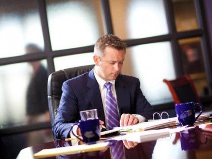 A man in a suit and tie is wearing glasses.