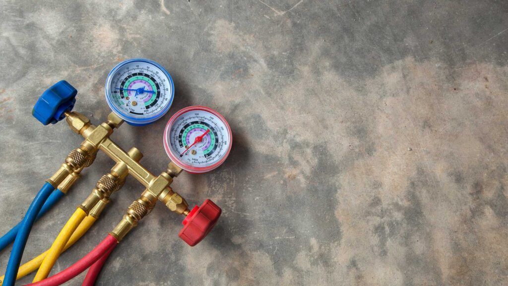 A bunch of gauges and hoses on a concrete surface.