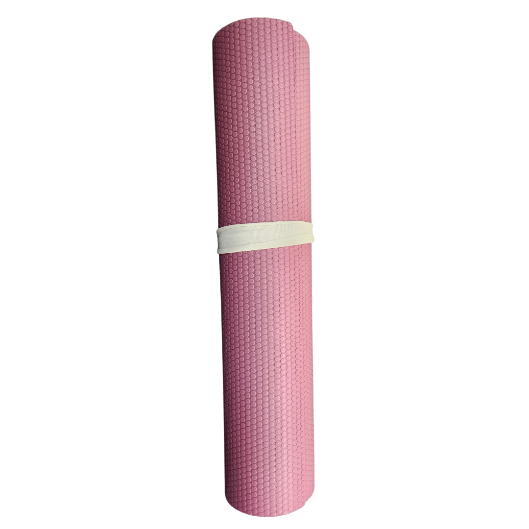 A pink yoga mat is rolled up on a white background.