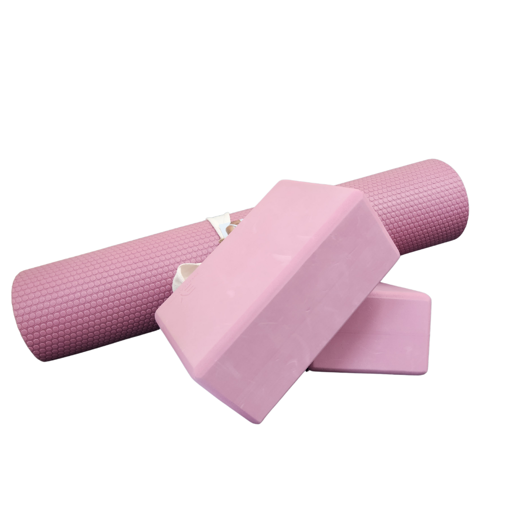 A pink yoga mat and two pink yoga blocks on a white background