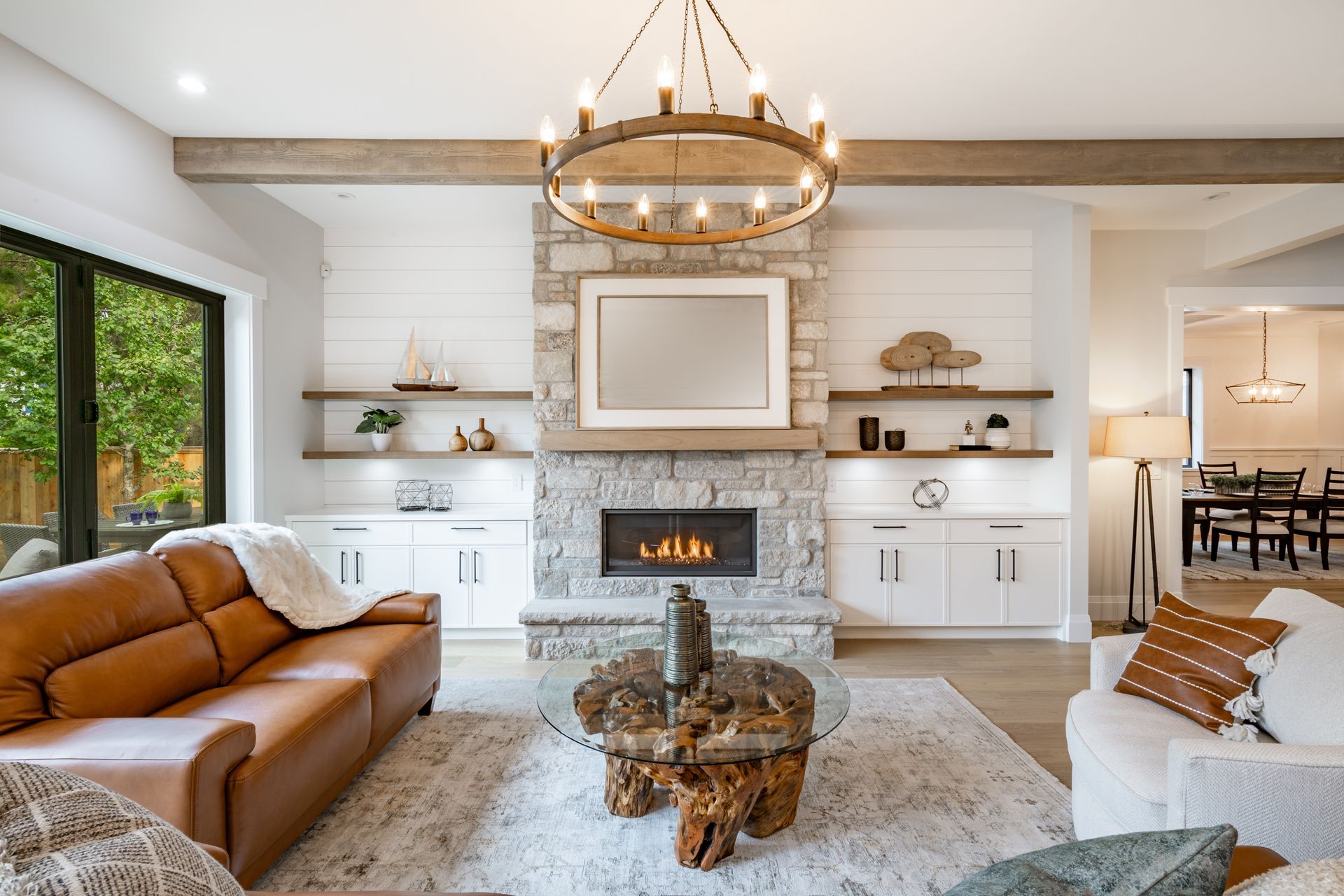 Living room with fireplace, brown leather sofa, and wooden coffee table.