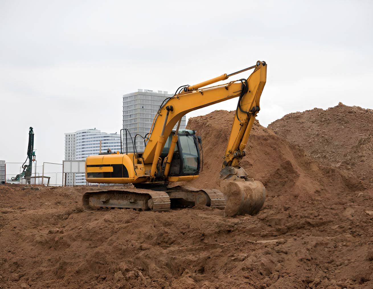A Yellow Excavator Is Moving Dirt On A Construction Site — Absolute Dingo Services in White Rock, QLD