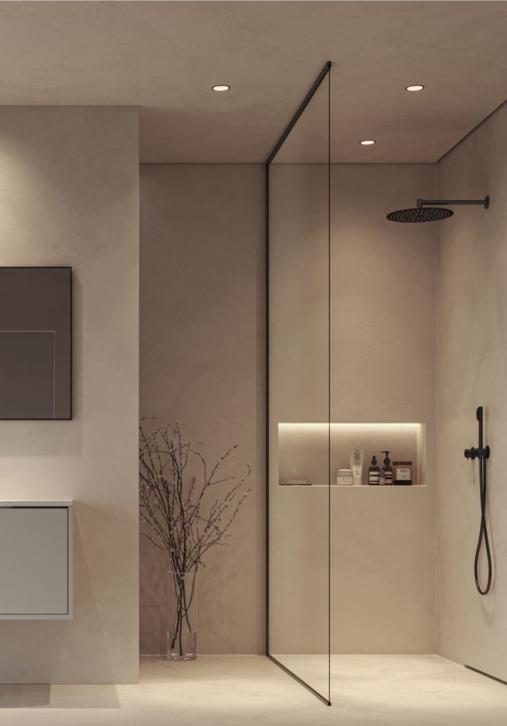 Modern bathroom with a glass shower enclosure, neutral tones, and minimalist decor.
