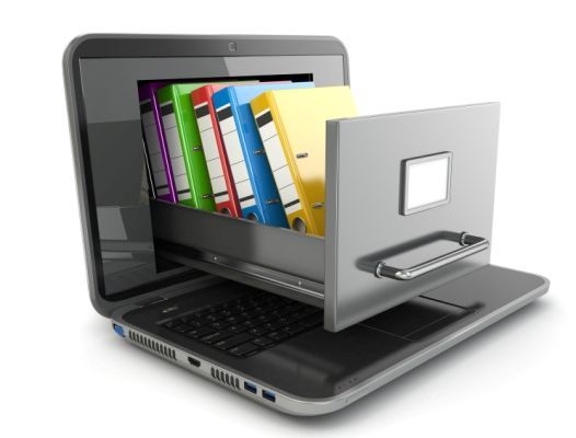 Laptop with an open drawer containing colorful file folders, symbolizing digital file storage.