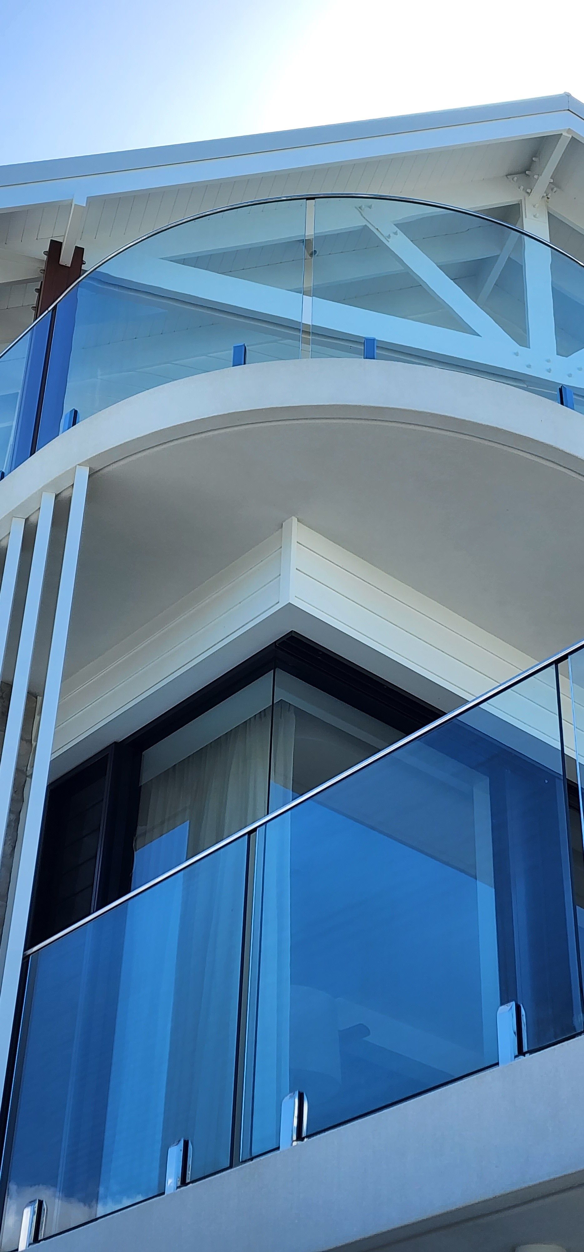 Modern building with blue glass balconies.