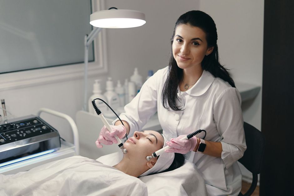 A woman is getting a facial treatment at a beauty salon.