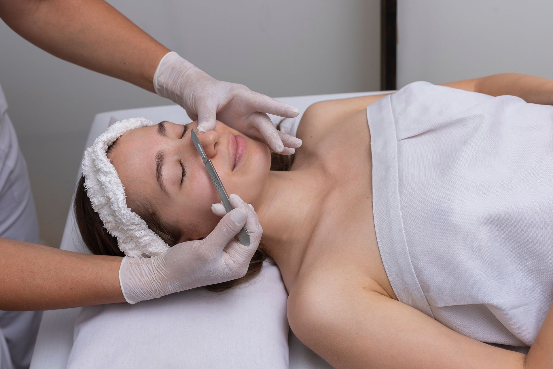 a woman in a dermaplaning session.