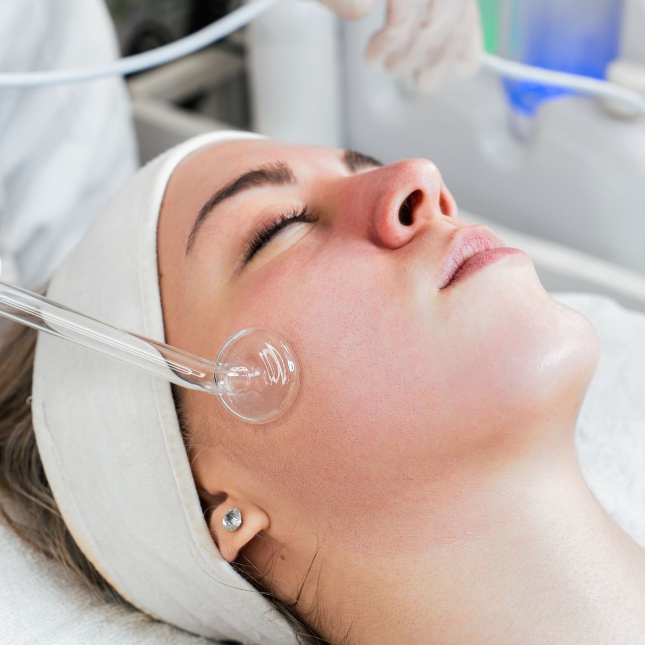 A woman is getting a treatment on her face