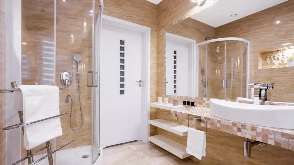 Remodeled bathroom with white & tan tile