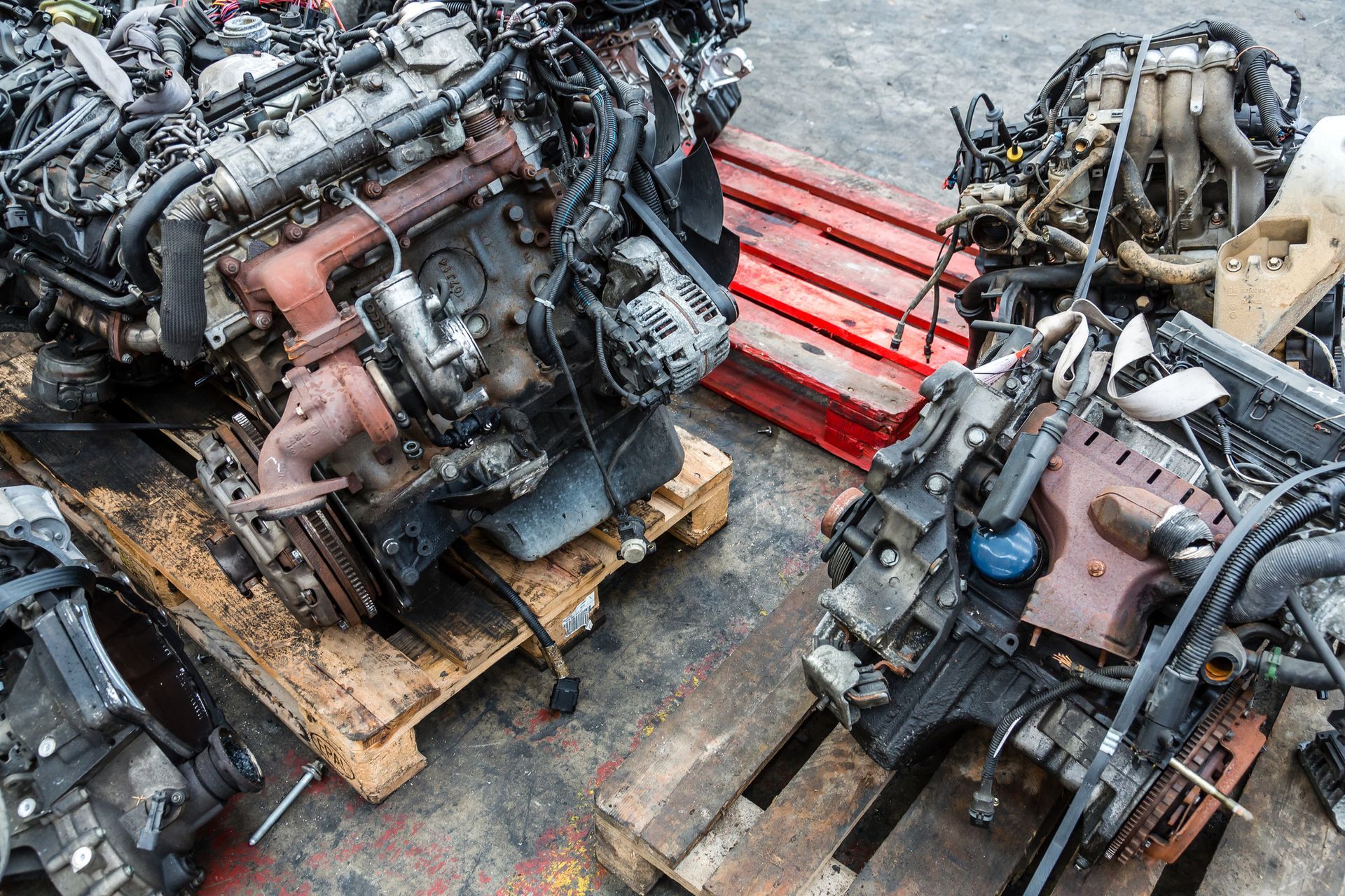 Used car engines stacked and ready for recycling or reuse in auto salvage operations.