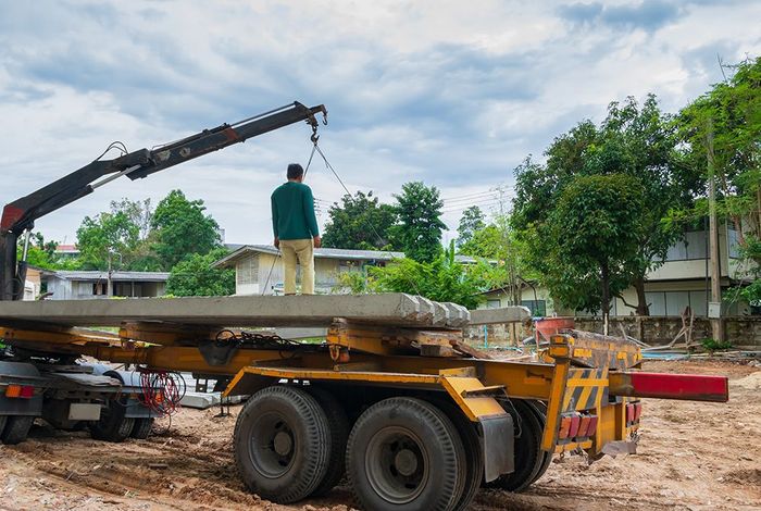 a man standing on the back of a truck