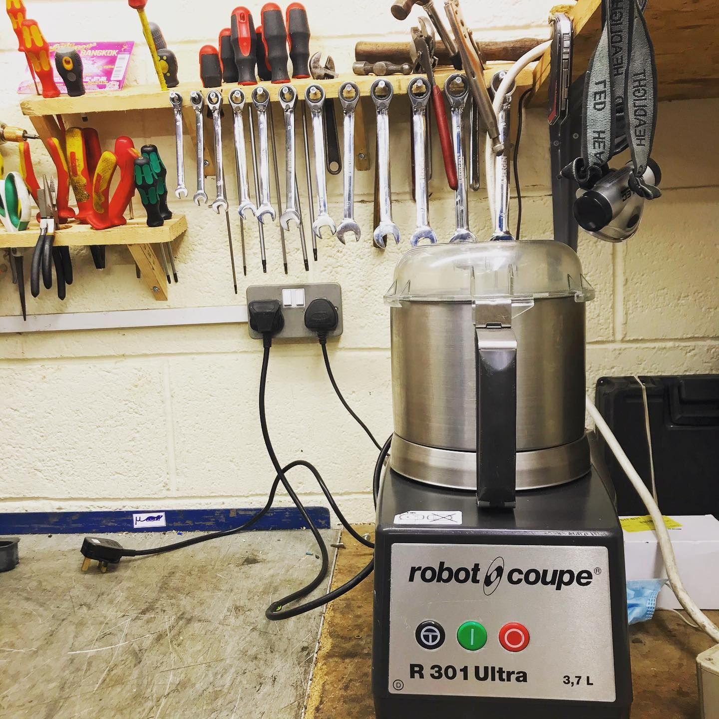 a robot coupe r301 ultra sits on repair workstation