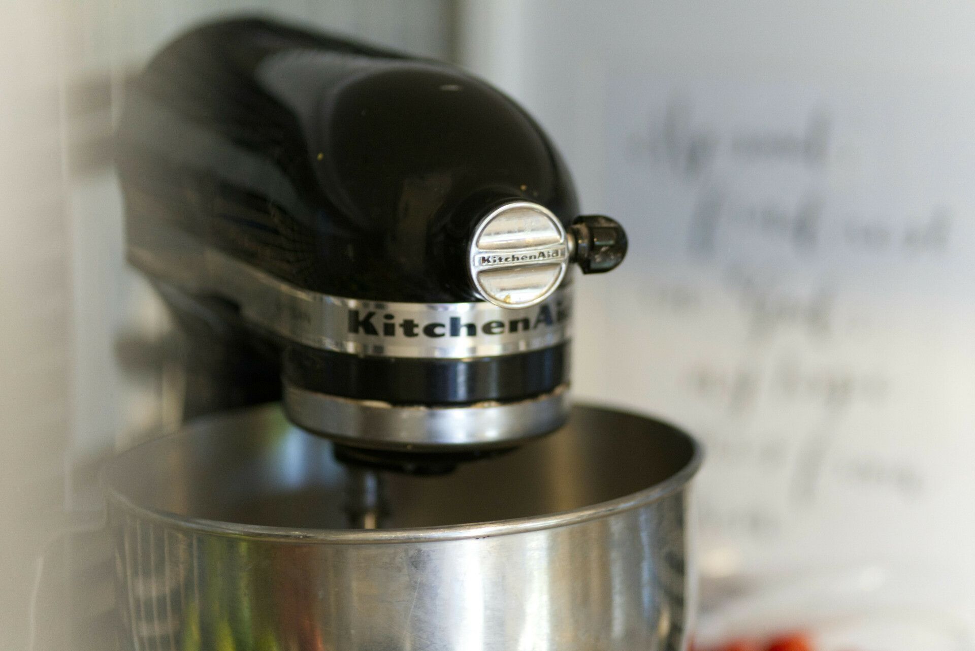 A black kitchenaid mixer is sitting on a counter