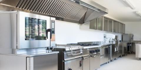 A kitchen with stainless steel appliances and a convection oven.