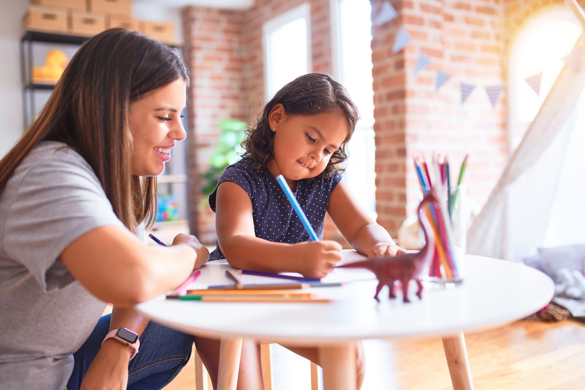 A person and a child drawing