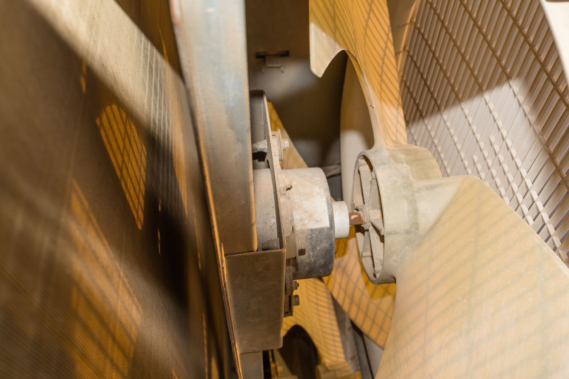Close-up of a large industrial fan with visible blades and motor.