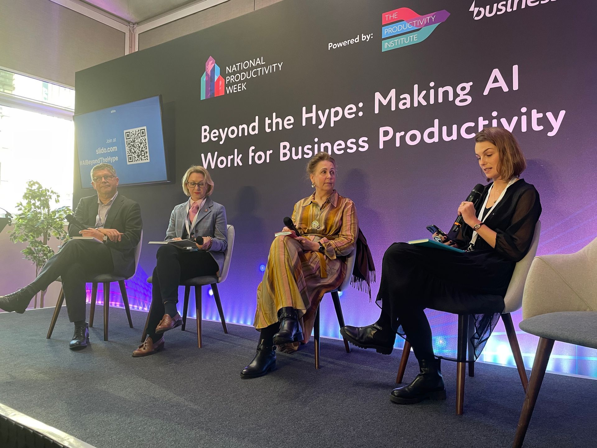 An image of speakers on the stage at Beyond the Hype, Making AI Work for Business conference. A grey-haired man, PROF BART VAN ARK, Managing Director at The Productivity Institute; JURGA ZILINSKIENE MBE, Founder & CTO of Guildhawk; TERA ALLAS CBE
Director of Research and Economics, McKinsey & Co, and MEGAN CARNEGIE Journalist and event moderator