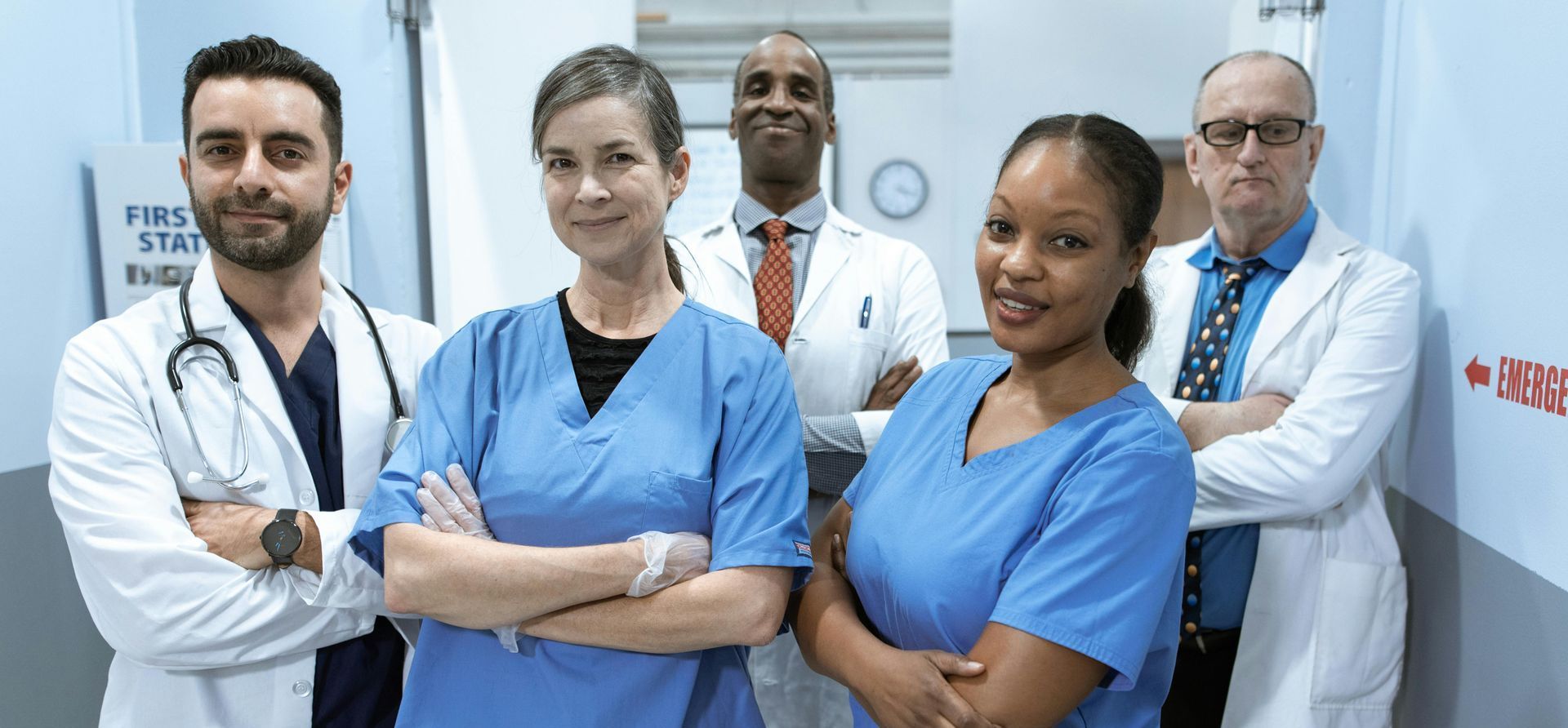 A group of doctors standing, arms crossed