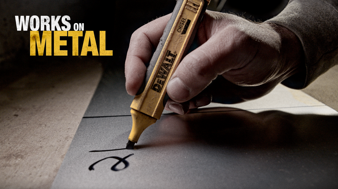 Hand writing on metal with a yellow marker, 