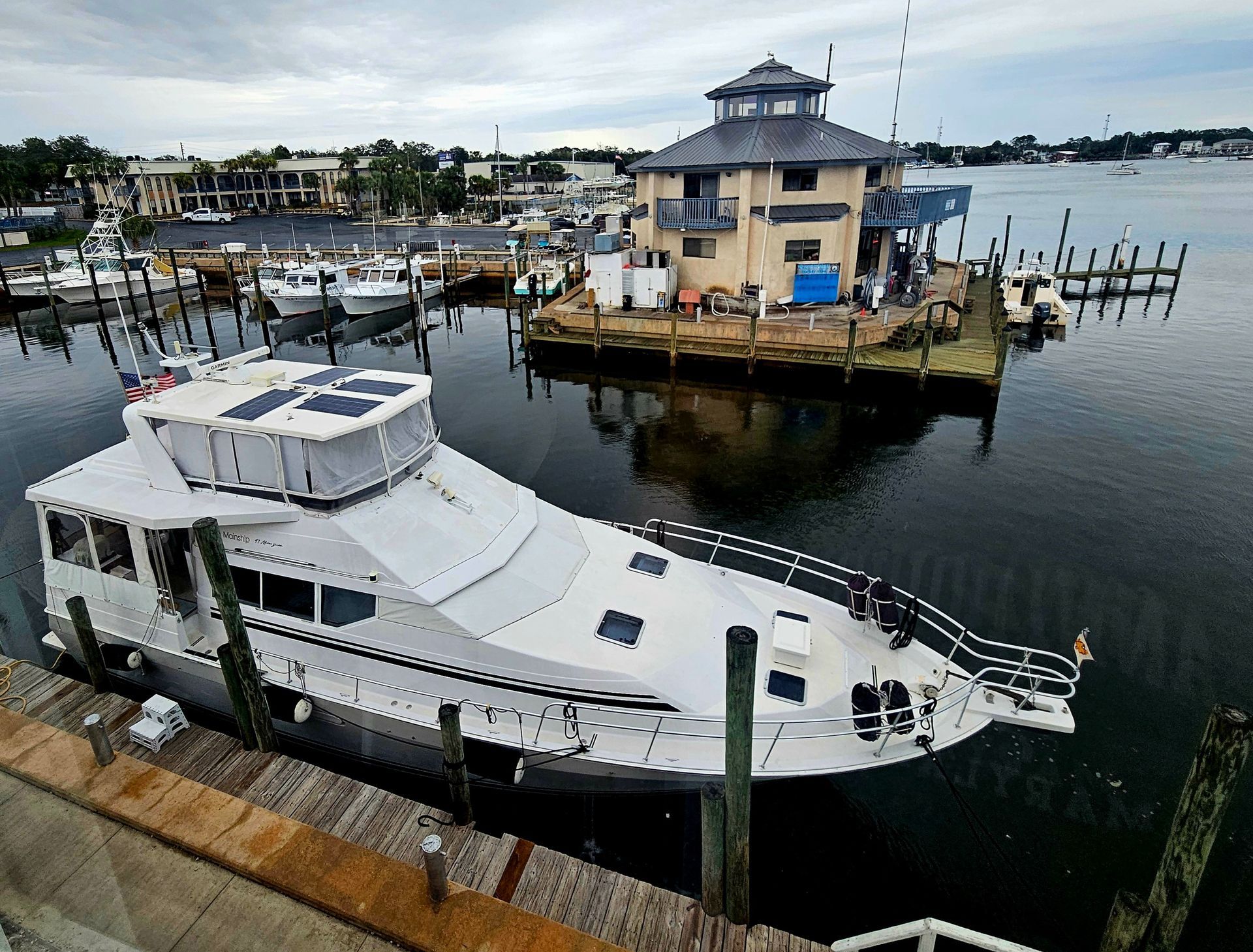 A white boat is floating on top of a body of water.