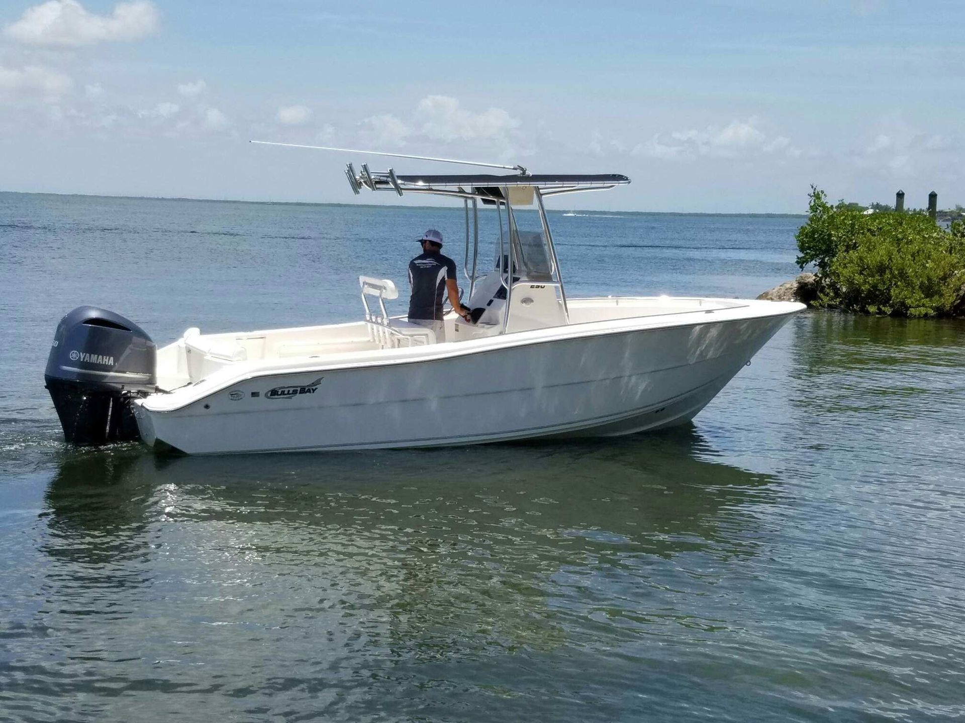 A white boat is floating on top of a body of water.