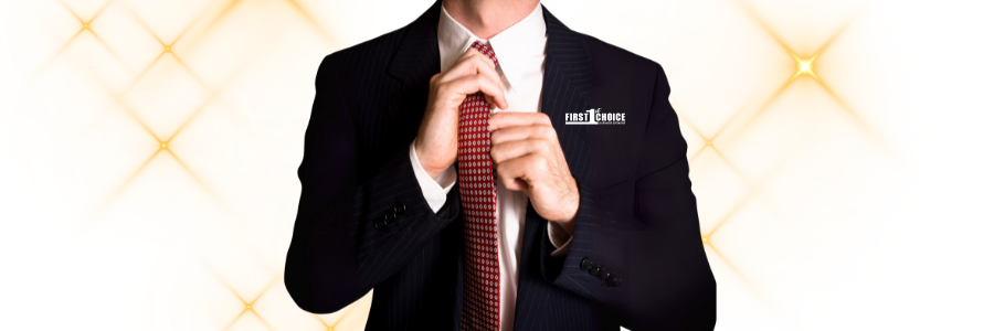 Person in suit adjusting a red tie.