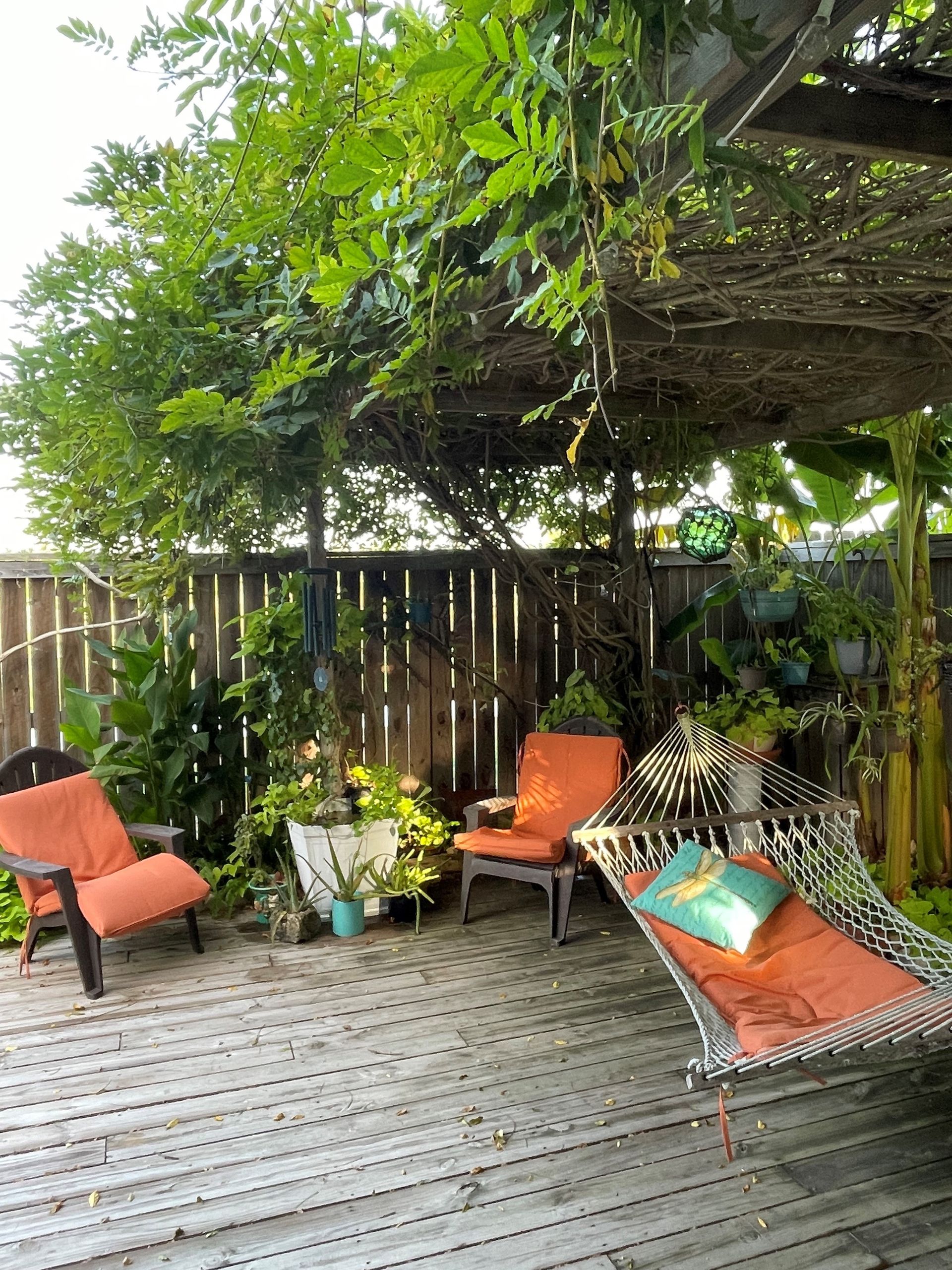 There is a hammock and chairs on the deck.