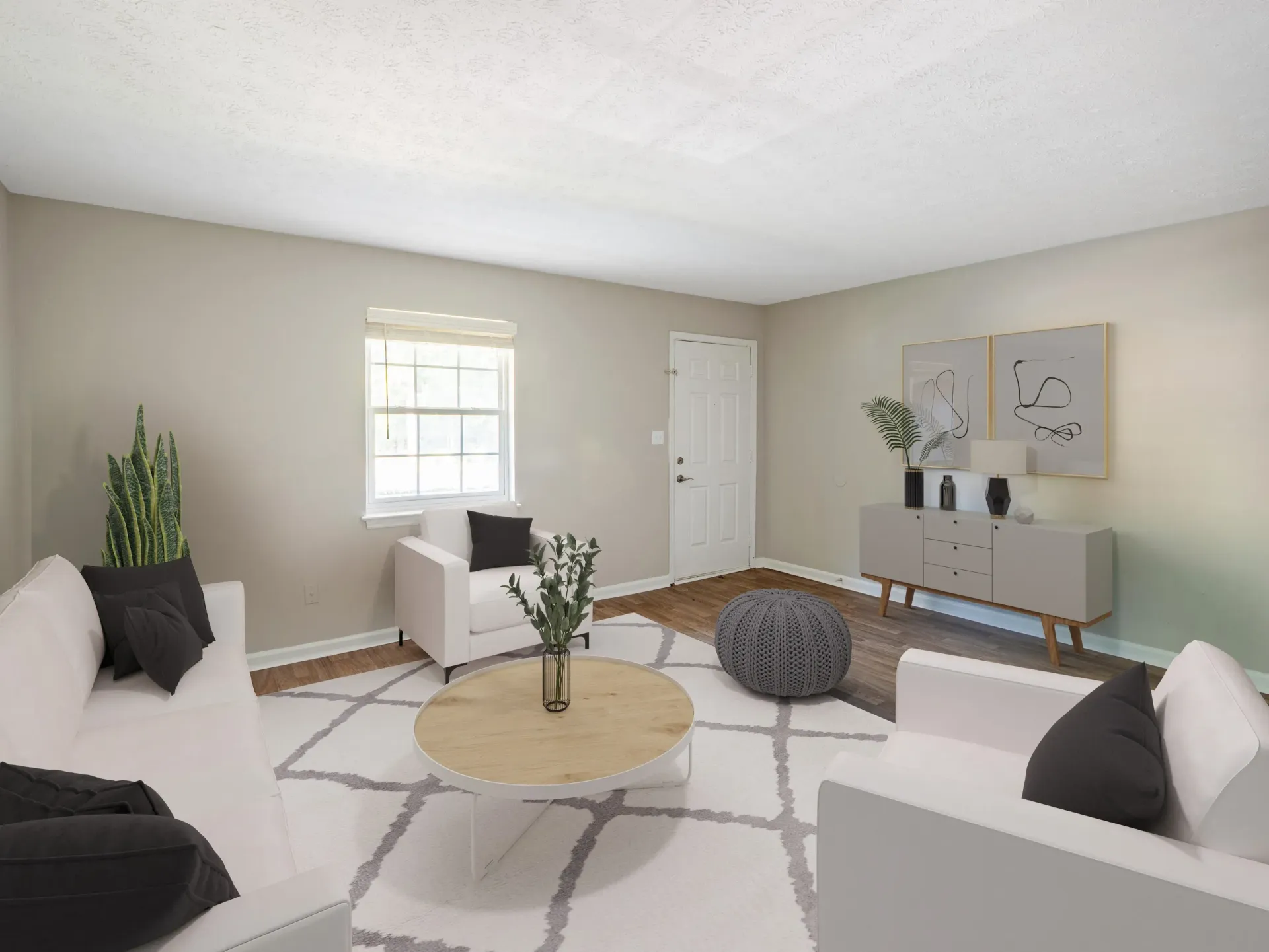 Living room with white furniture, rug, light wood coffee table, and gray console table at The Arbors at Smyrna, offers townhomes for rent in Smyrna, GA.