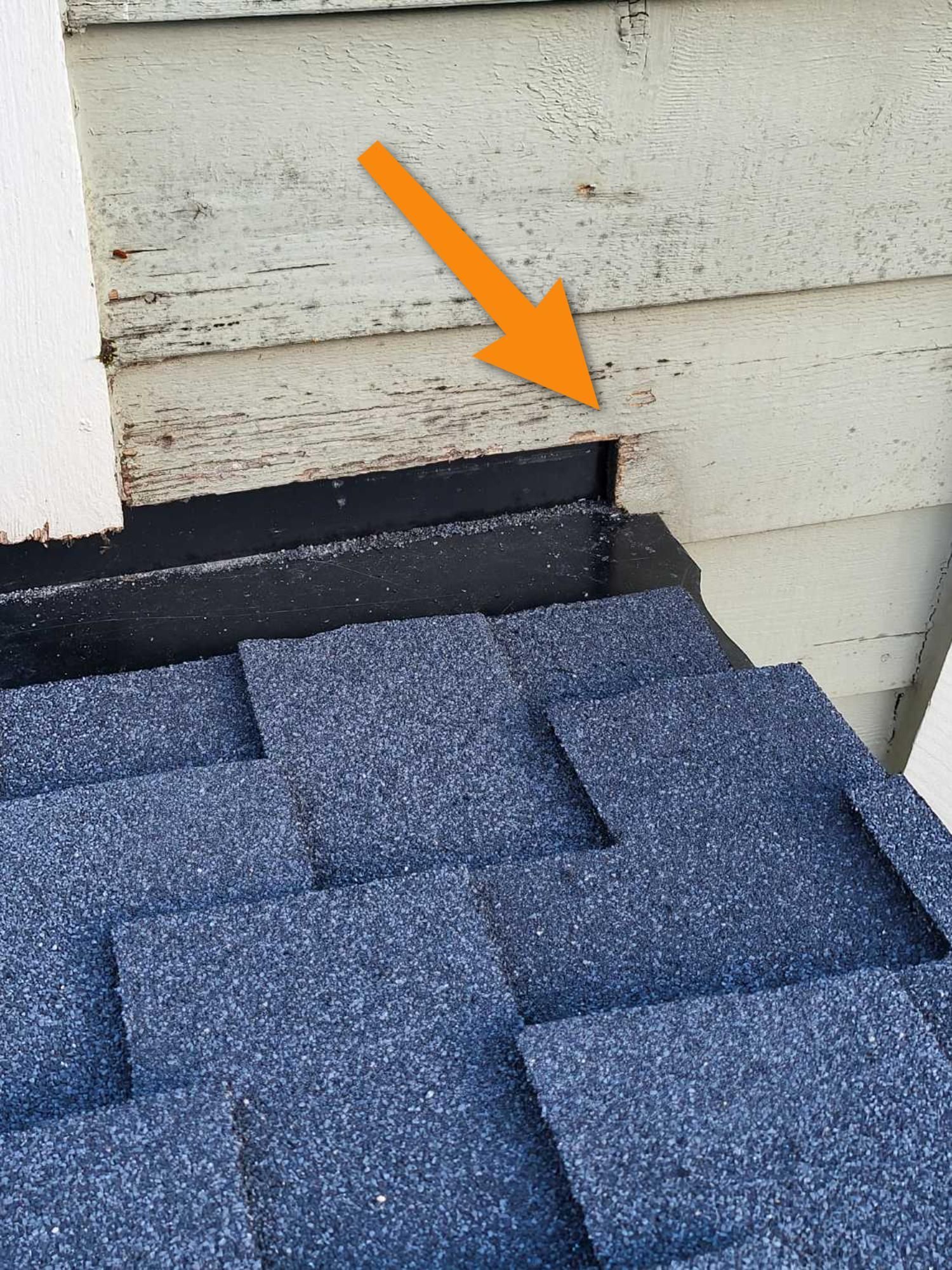 A close up of a blue roof with an orange arrow pointing to it.