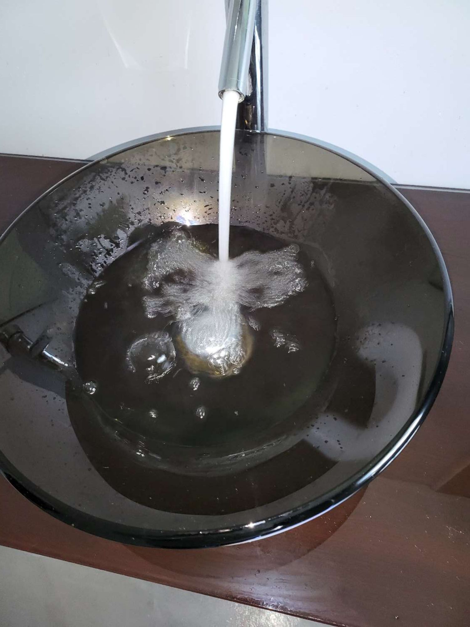 A bathroom sink with water running from a faucet.