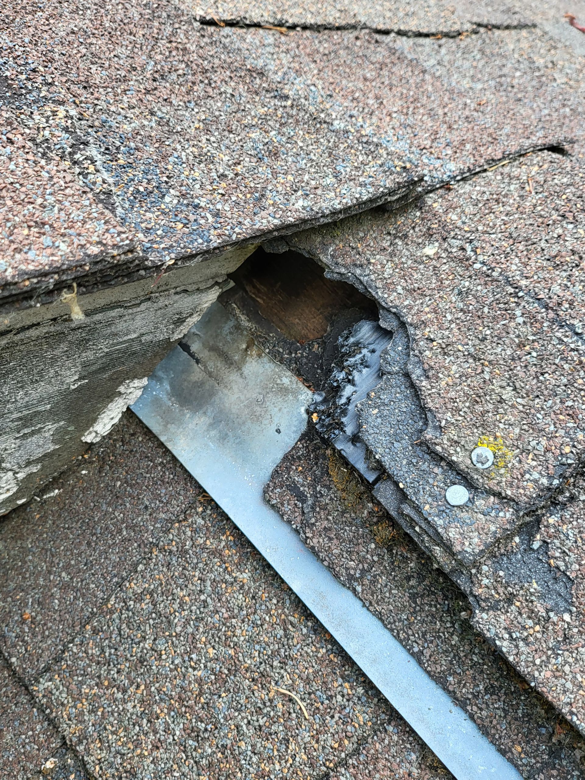 A close up of a roof with a hole in it.