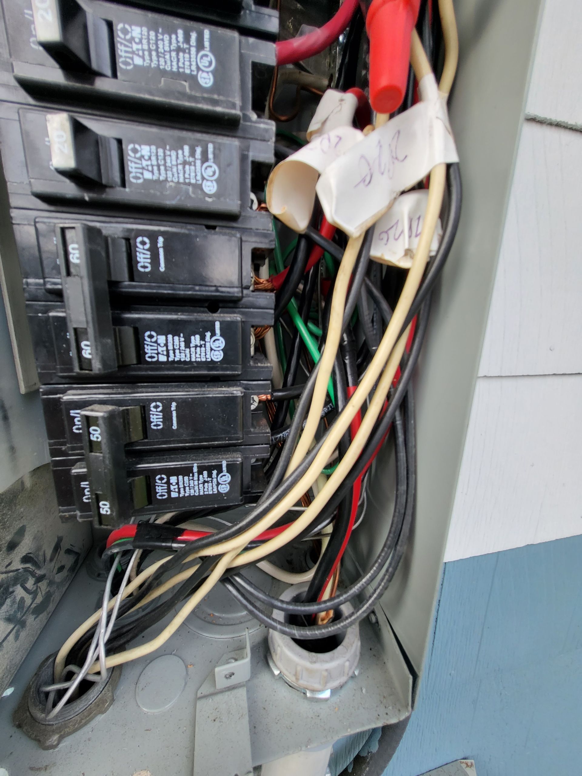 A bunch of wires are coming out of a electrical box