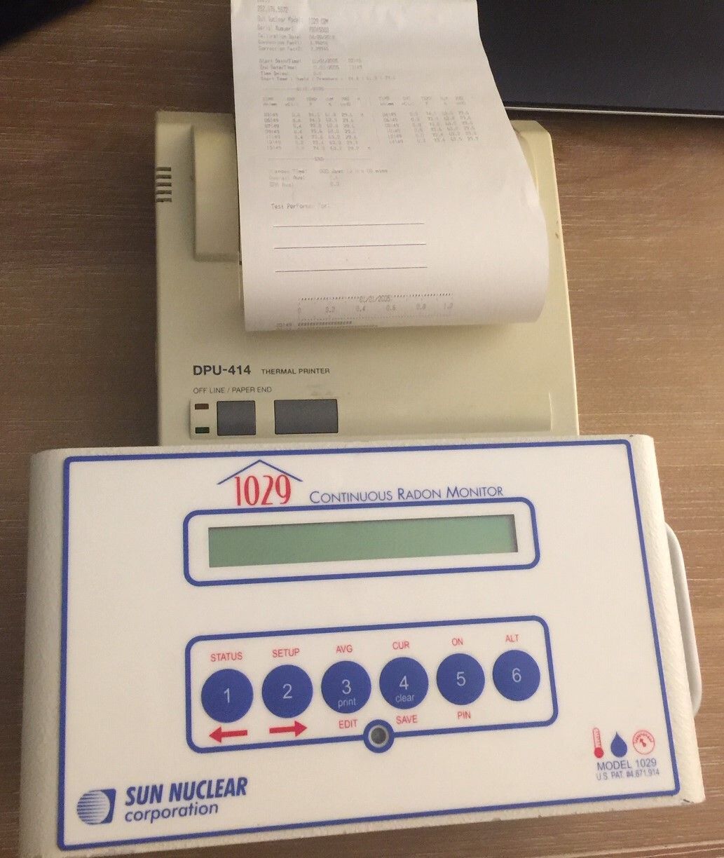 A sun nuclear corporation device with a receipt coming out of it